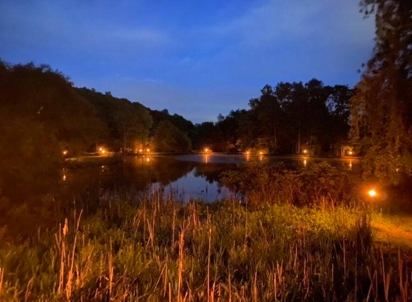 Half Baked Homestead view of lanterns around the pond at night